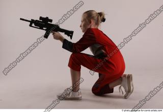 DENISA KNEELING POSE WITH GUN
